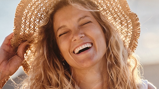 women with beautiful smile on the beach