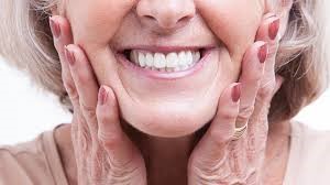 Woman Smiling and Showing Her Dental Implants 